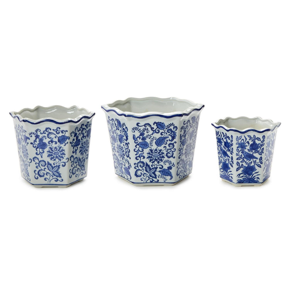 Three blue and white ceramic planter pots of different sizes in small,medium,large with a floral pattern and scalloped edges, arranged on a white background.
