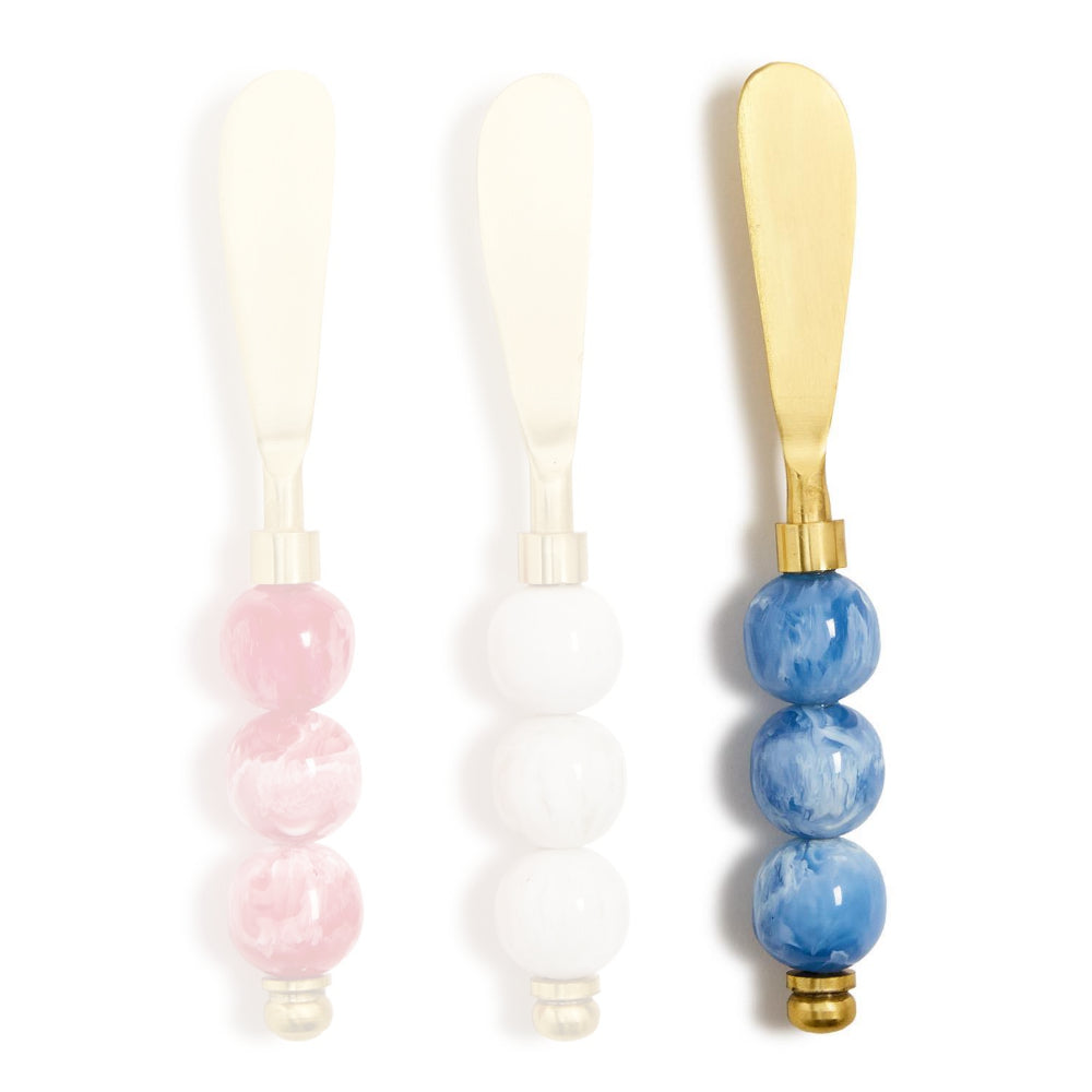 Blue handled gold cheese knives with colorful blue marble resin handle  on a white background