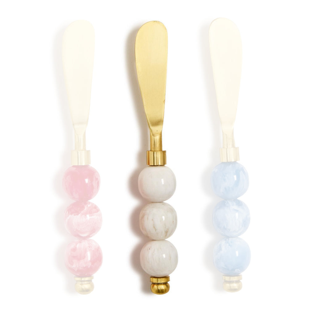 White handled gold cheese knives with colorful white marble resin  handle  on a white background