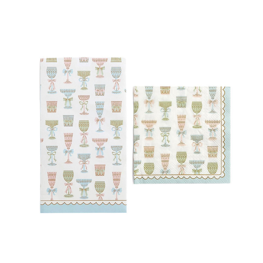 Two with patterned Cocktail & Dinner napkins with a colorful decorative wine bottle designs and a blue edge on a white background.