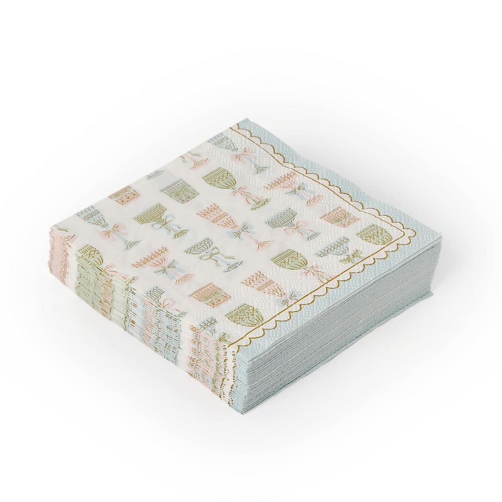 Square Cocktail napkins with decorative colorful wine bottle designs and a bottom and side blue & white scalloped edge on a white background.