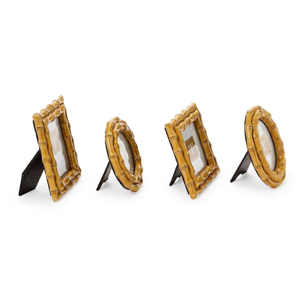 A side photo of four tan bamboo-style picture frames in sizes: round, square, rectangle & round on a white background.