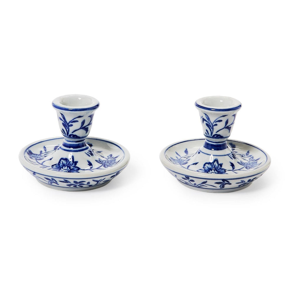 A pair of blue and white ceramic candlestick holders with floral patterns, displayed side-by-side on a clean white background.