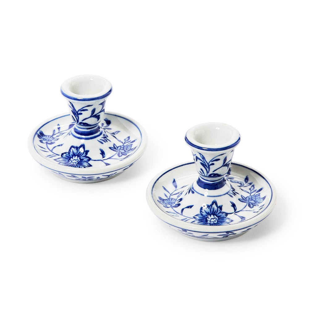 Two small blue-and-white ceramic candlestick holders with floral patterns, shown on a clean white background.