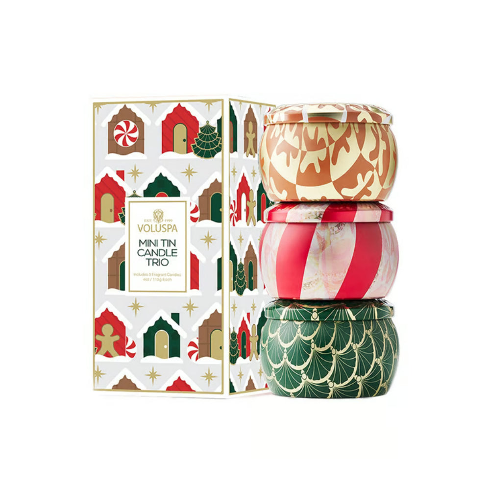 Voluspa Mini Tin Candle Trio with its illustrated gift box, featuring three patterned tins in holiday colors on a white background.