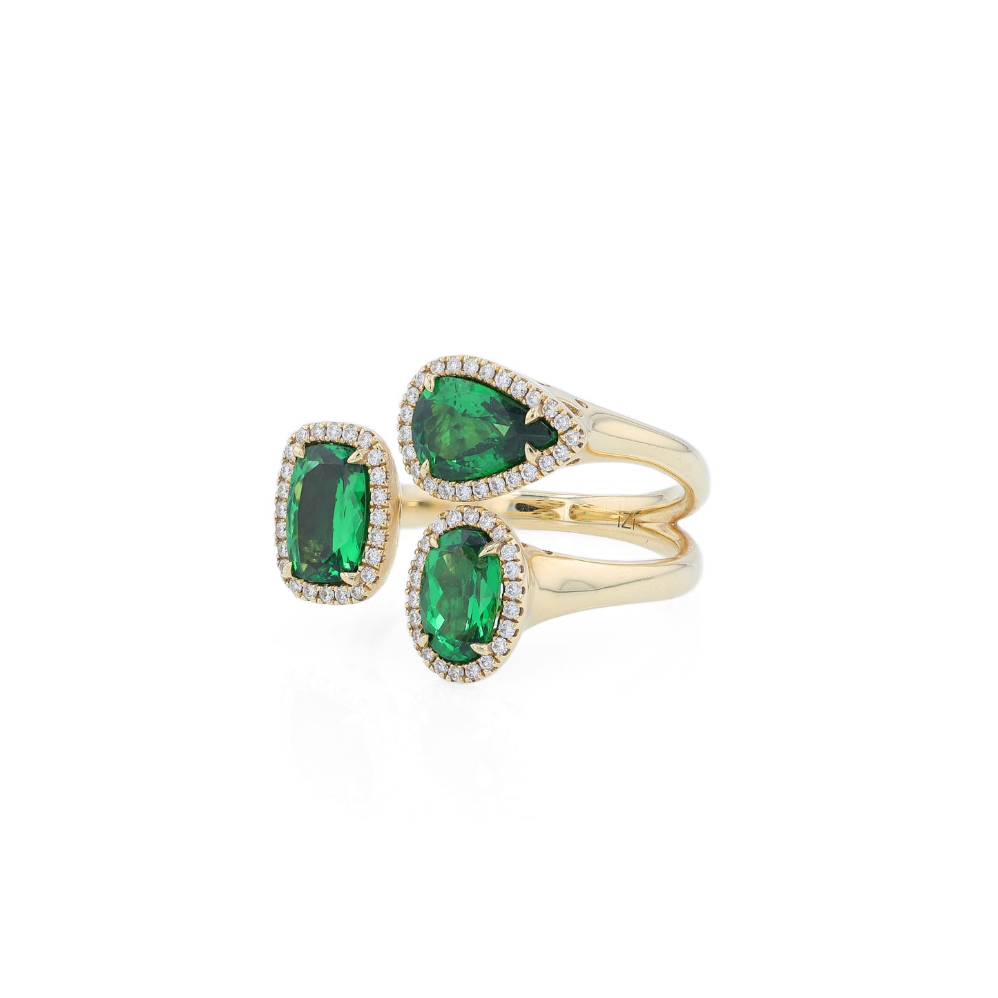 Gold ring with green tsavorite garnets and diamond halos on a white background