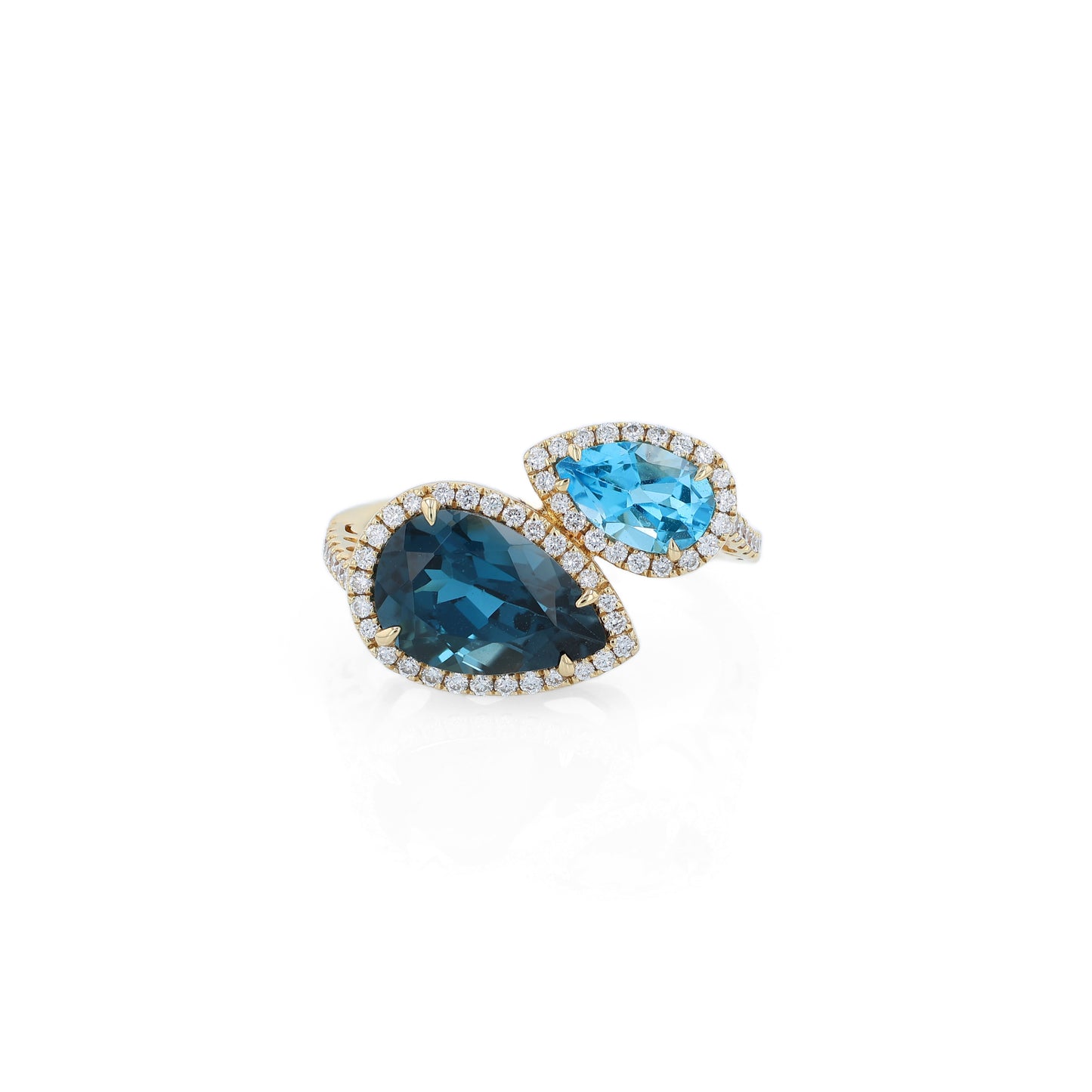 Yellow gold diamond halo bypass ring with 2 pear shape blue topaz on a white background