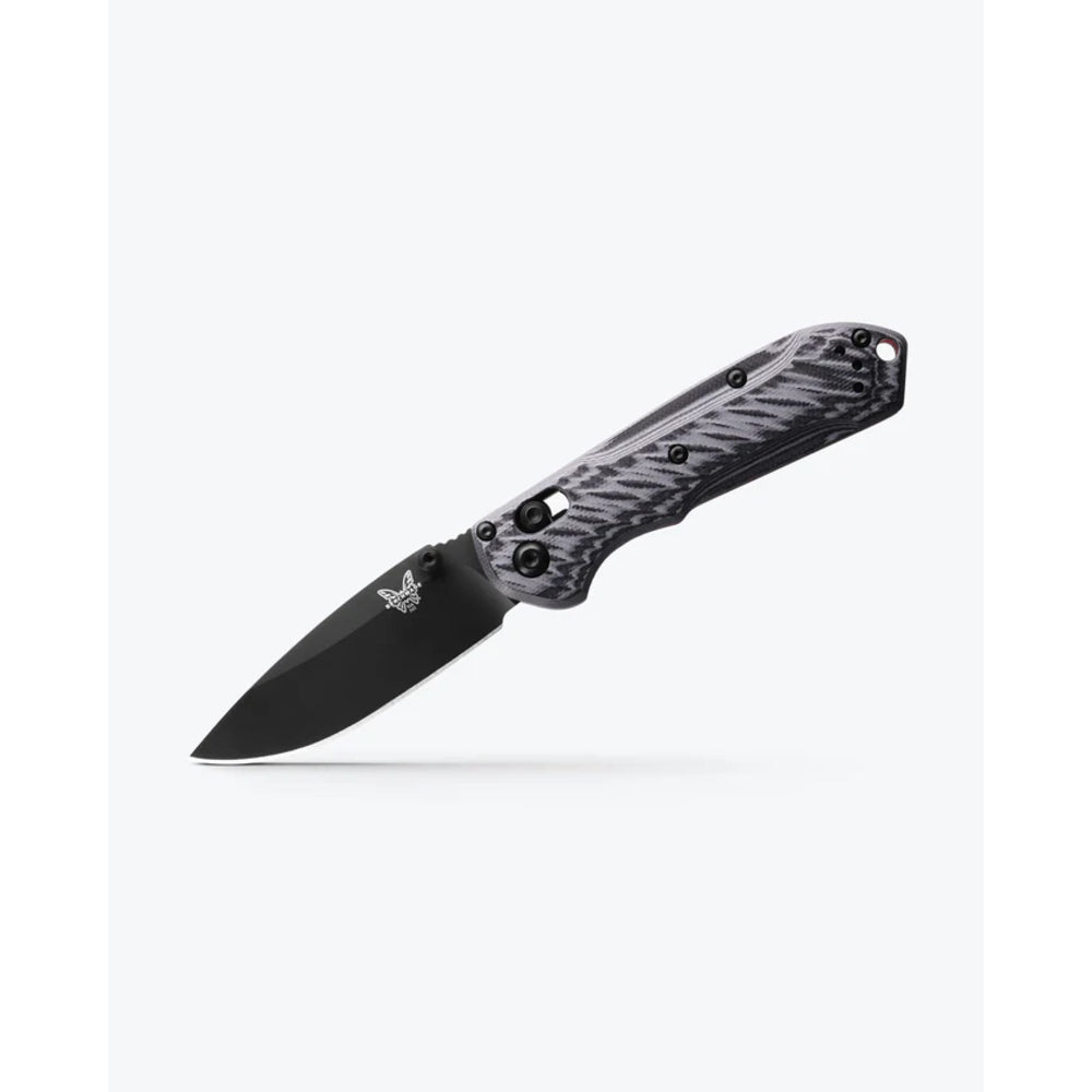 A folding pocket knife with a black blade and a textured black and gray handle, shown open against a light gray background.