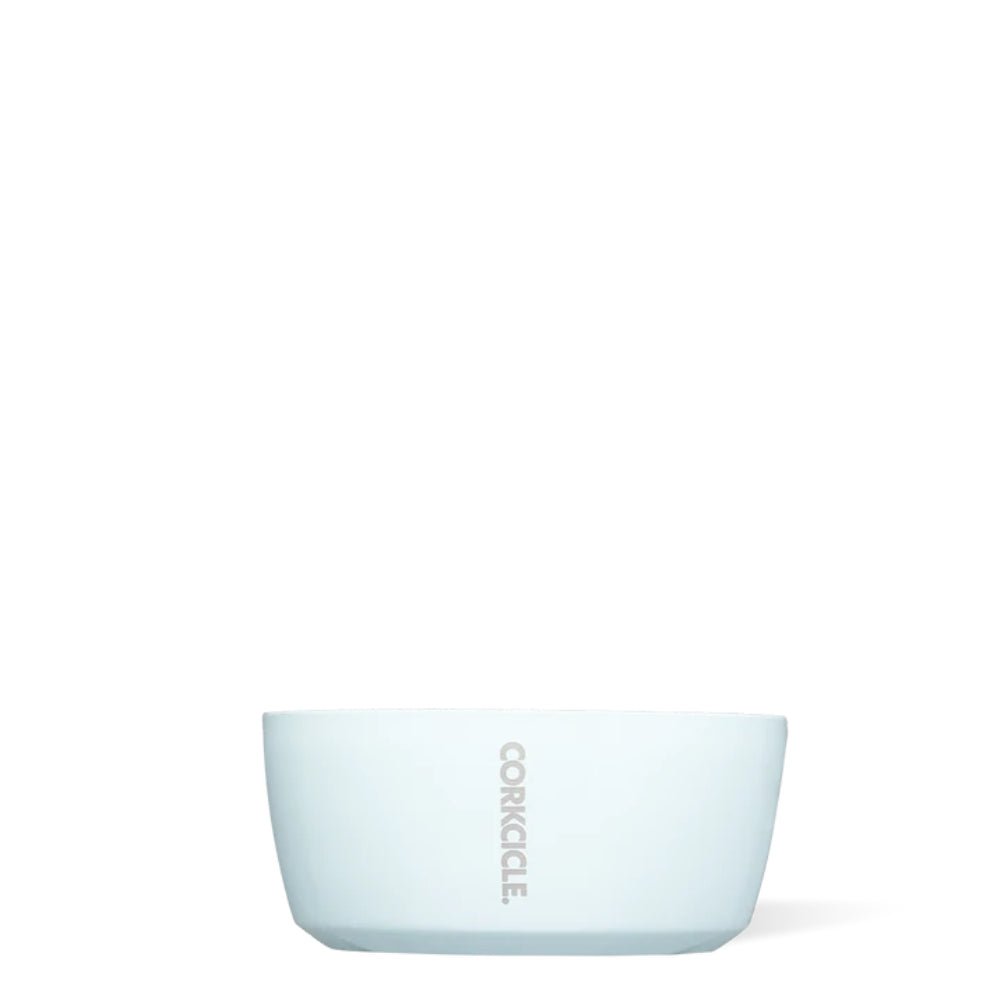 A powder blue, double-walled stainless steel dog bowl with a non-slip silicone bottom, branded with 'Corkcicle'.