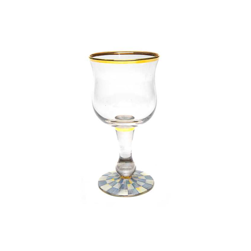 Clear glass with gold rim and decorative base royal blue checkard base on a white background