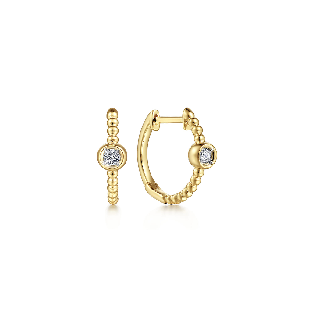 Gold hoop earrings with diamond accents on a white background