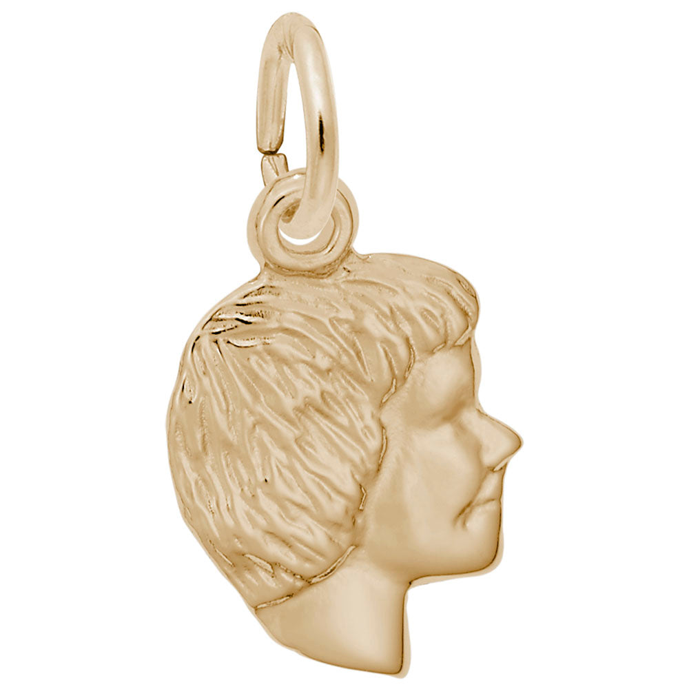 Gold charm of a profiled face on a white background
