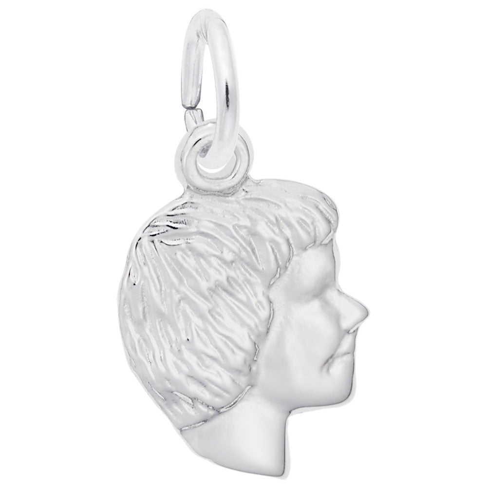 Silver charm of a profiled face on a white background