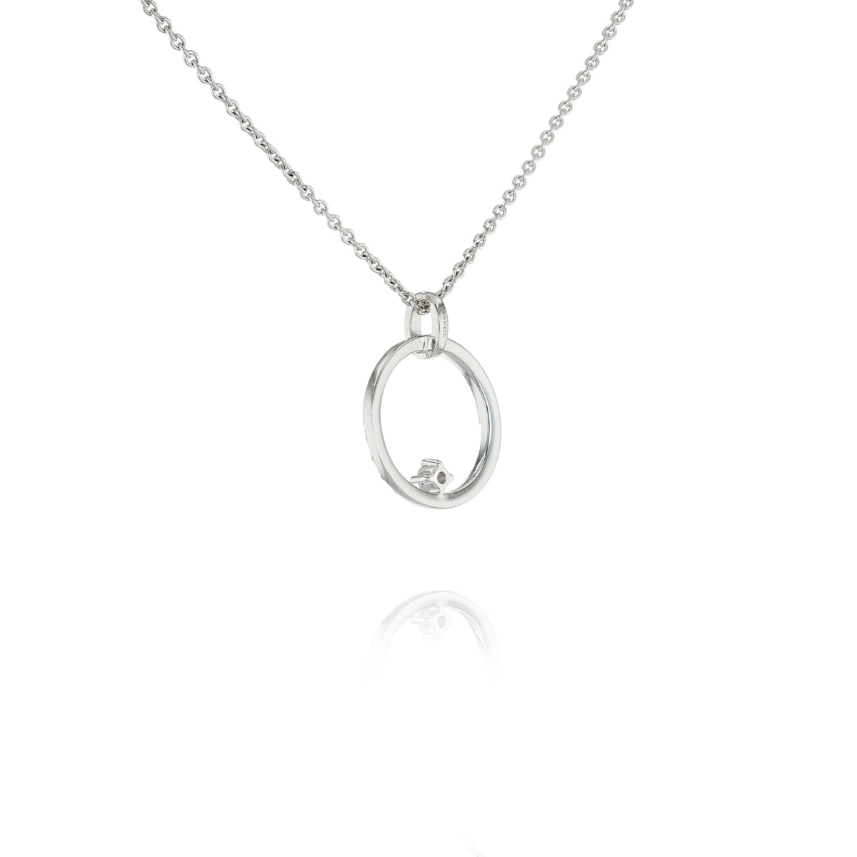A white gold necklace featuring an open oval pendant with a small, clear round gemstone, suspended from a delicate silver ball chain against a white background.