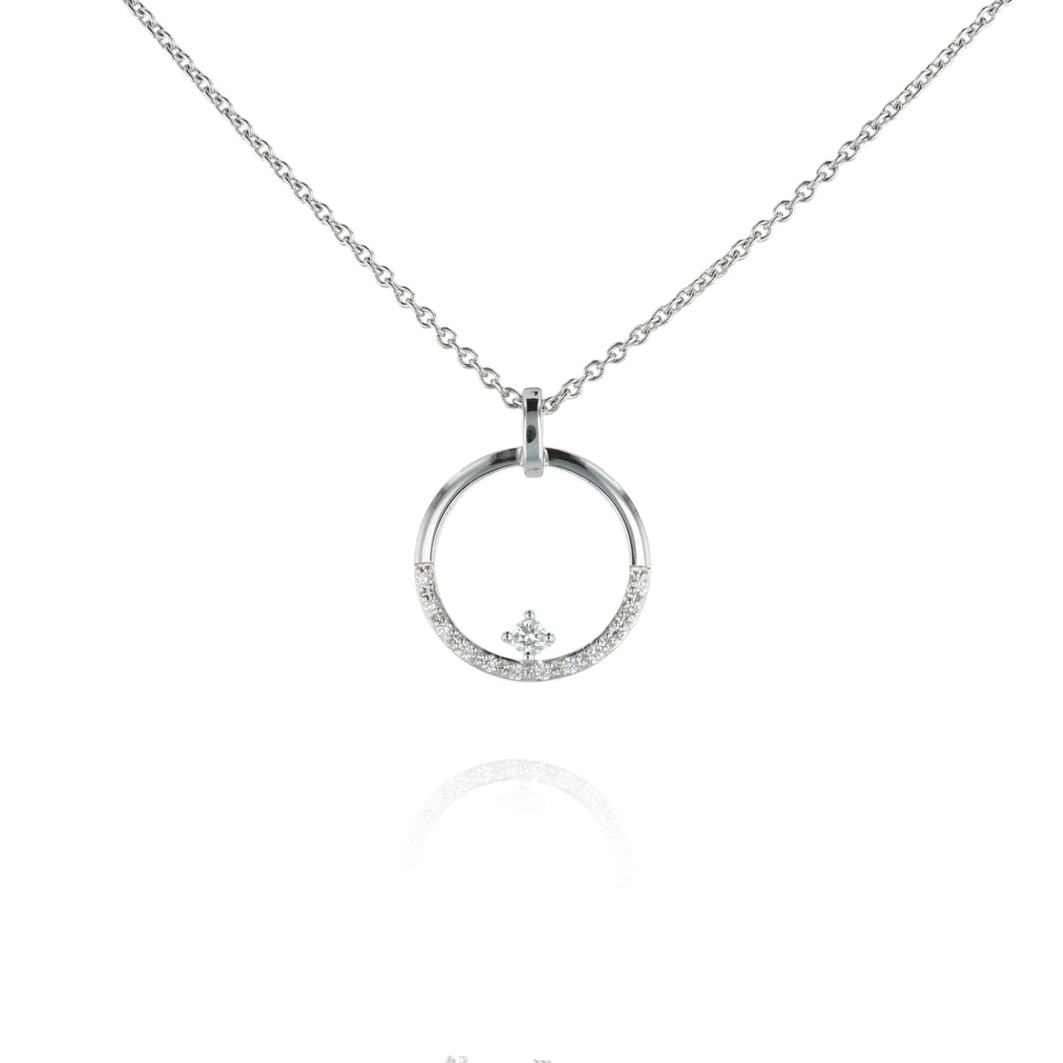 A white gold chain necklace with a circular pendant featuring a small crown motif and clear stones, shown on a white background with a faint reflection below.