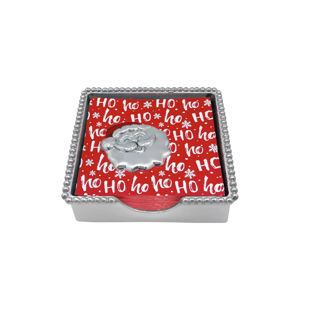 Happy santa beaded napkin holder with red ho ho napkins and santa weight on a white backround. 