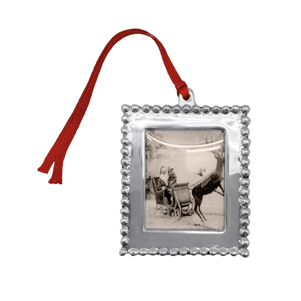 Beaded photo frame ornament with red hanger on a white backround. 