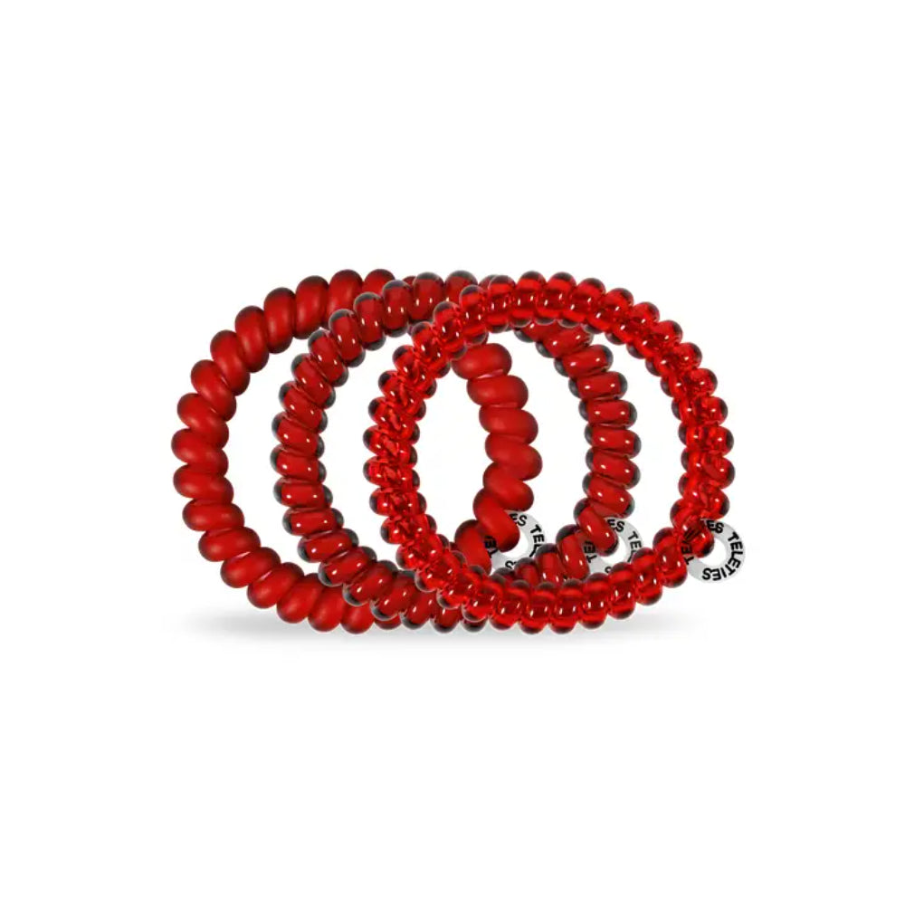 Red spiral hair ties on a white background