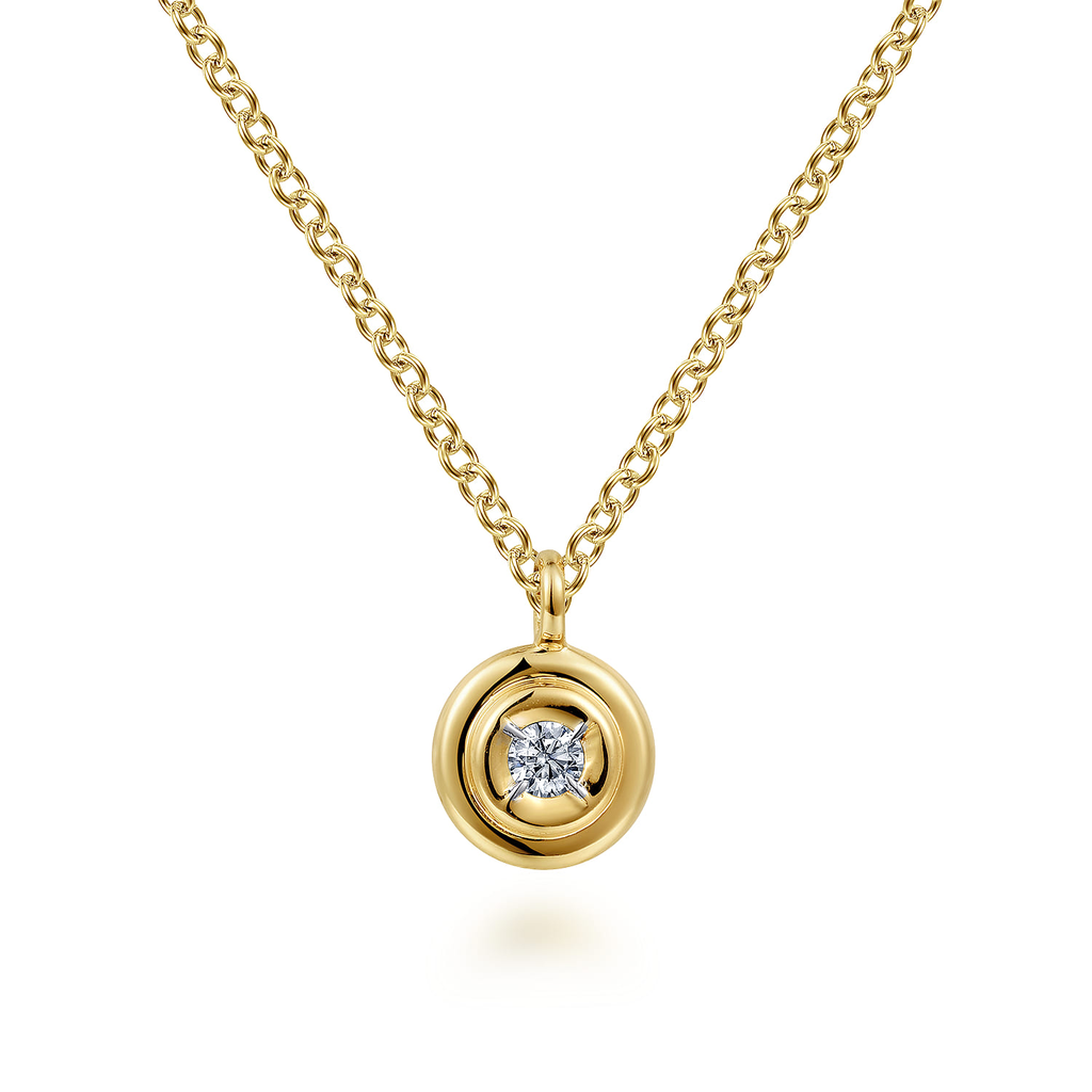 Gold necklace with a round diamond pendant on a white background