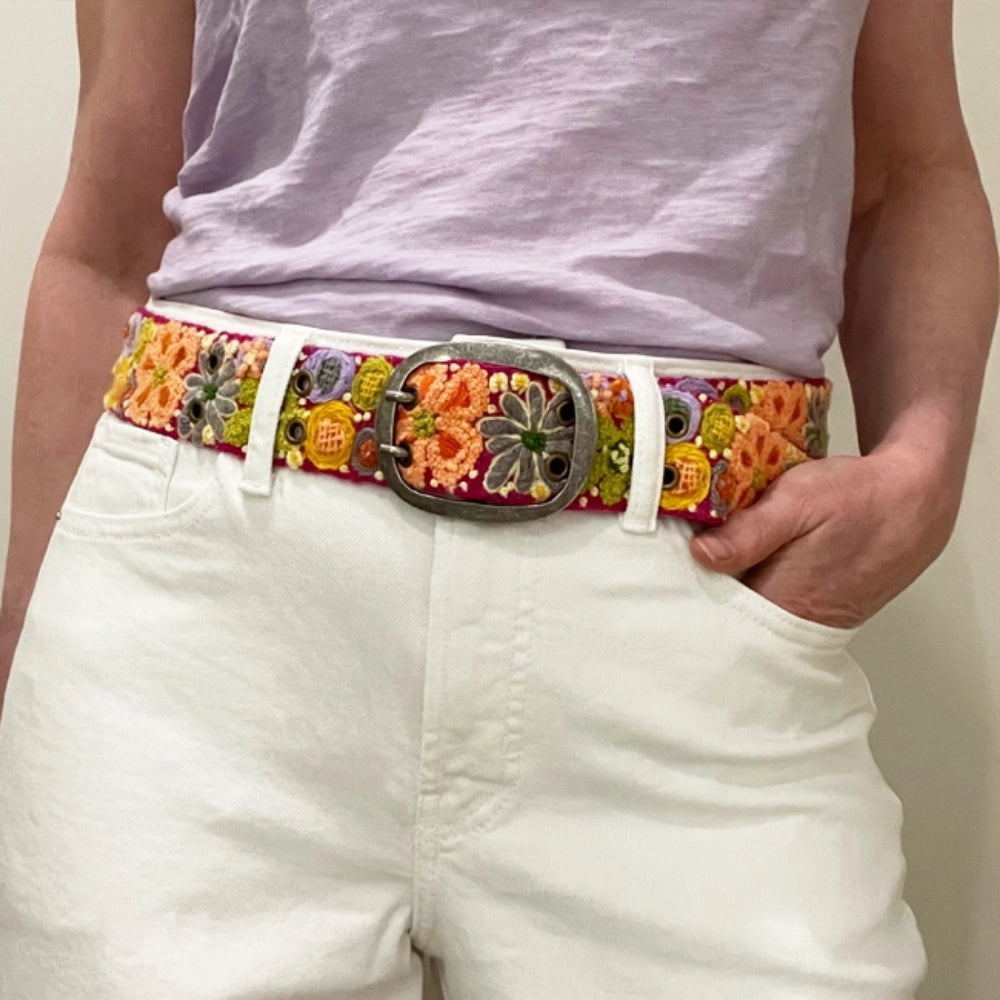 Person wearing a floral woven belt