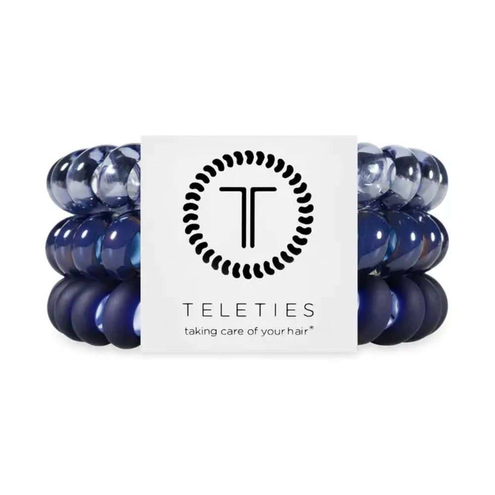 Set of blue hair ties with a Teleties branded label on a white background