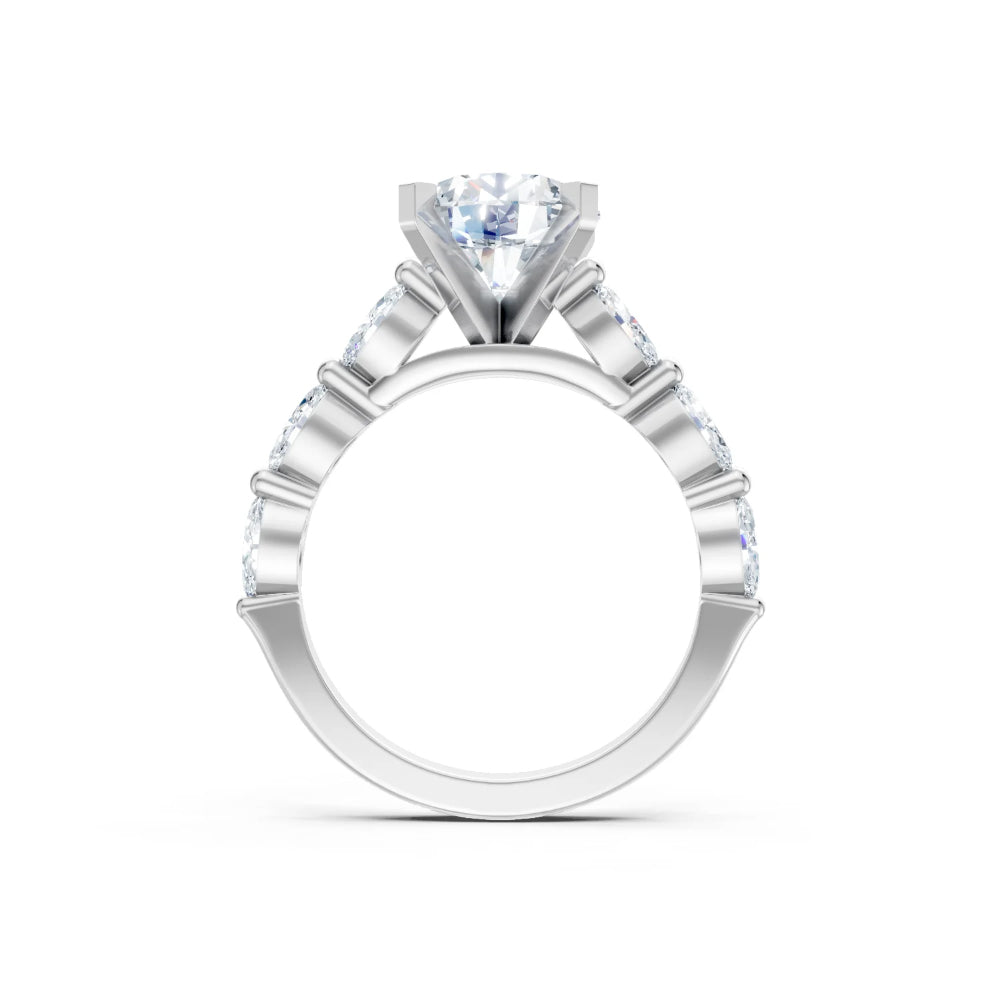 A silver-toned solitaire engagement ring featuring a round brilliant-cut center stone and a halo of smaller round stones along the shoulders, shown on a clean white background.