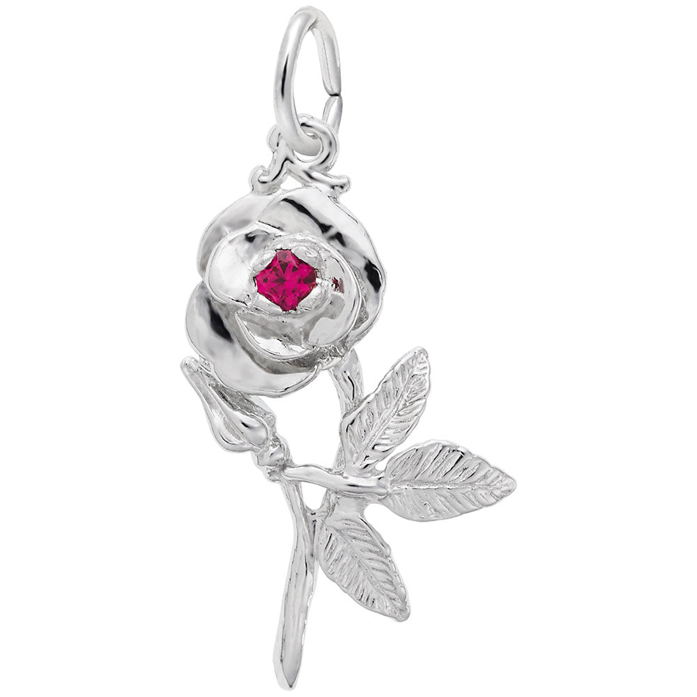 Silver flower shaped charm with a red stone in the center, shown on a white background