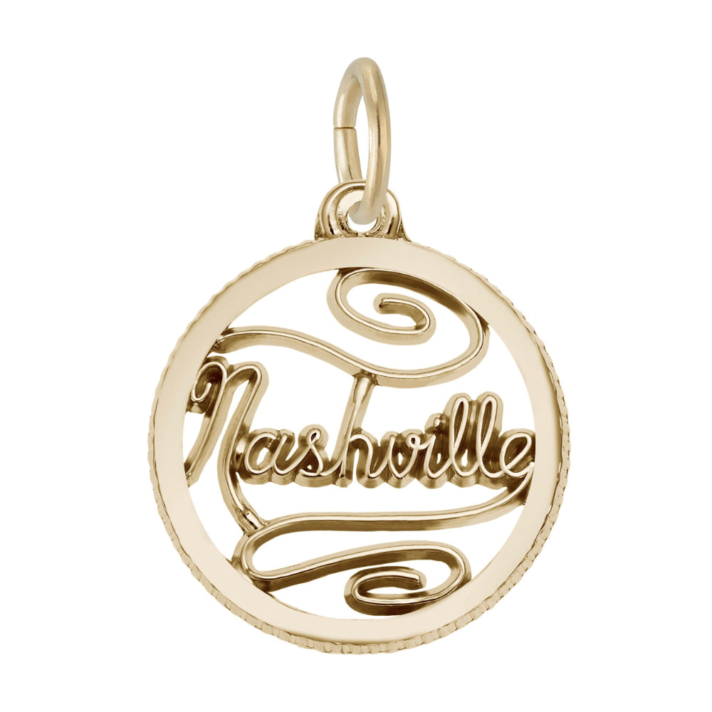A gold circular charm featuring the word 'Nashville' in cursive script, shown on a plain white background.