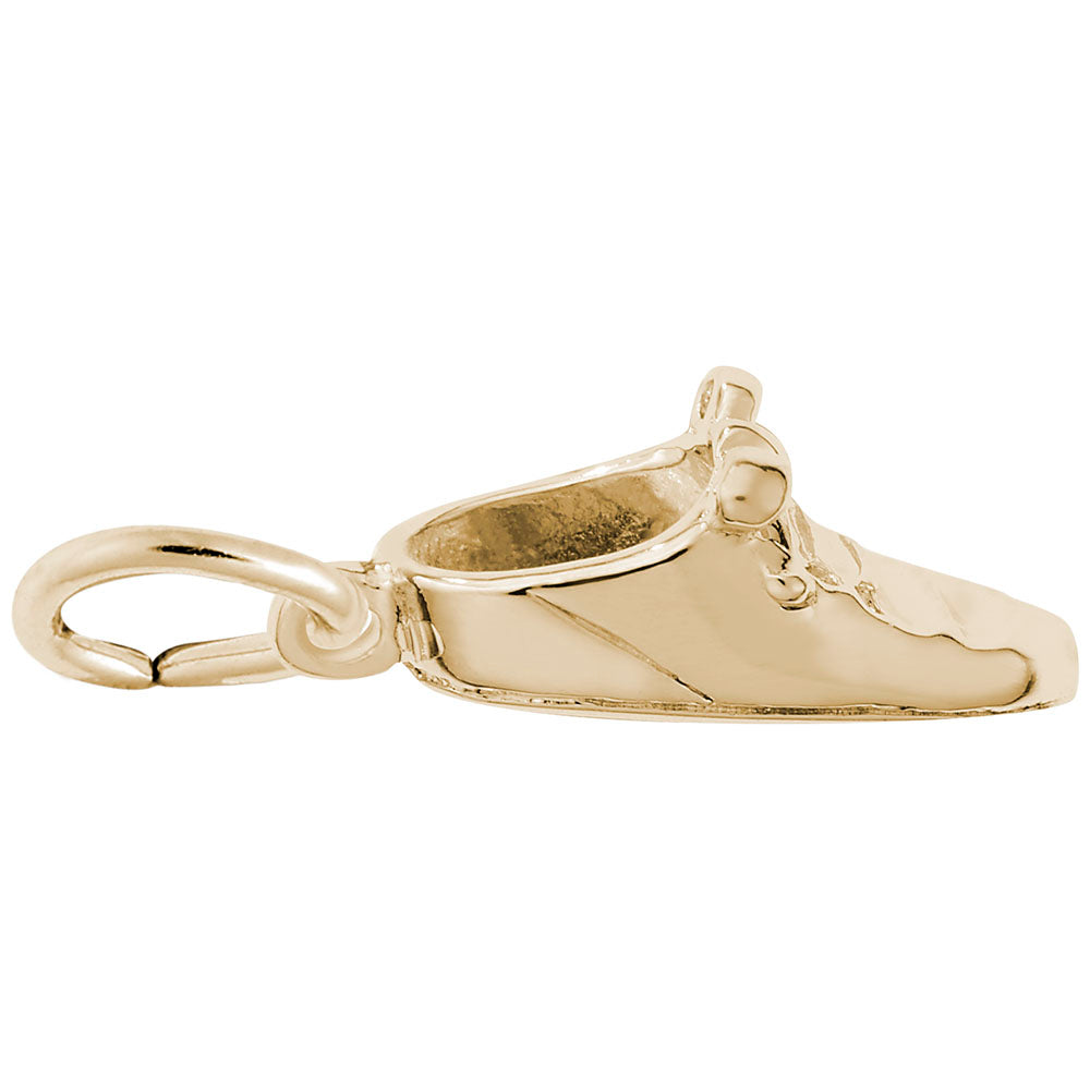 Gold shoe charm on a white background