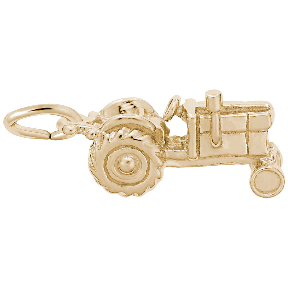 Gold tractor charm on a white background
