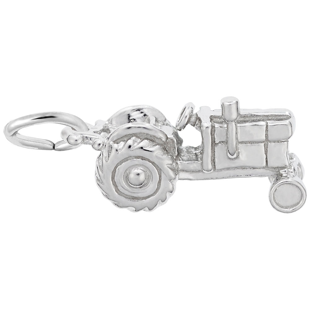 Silver tractor charm on a white background