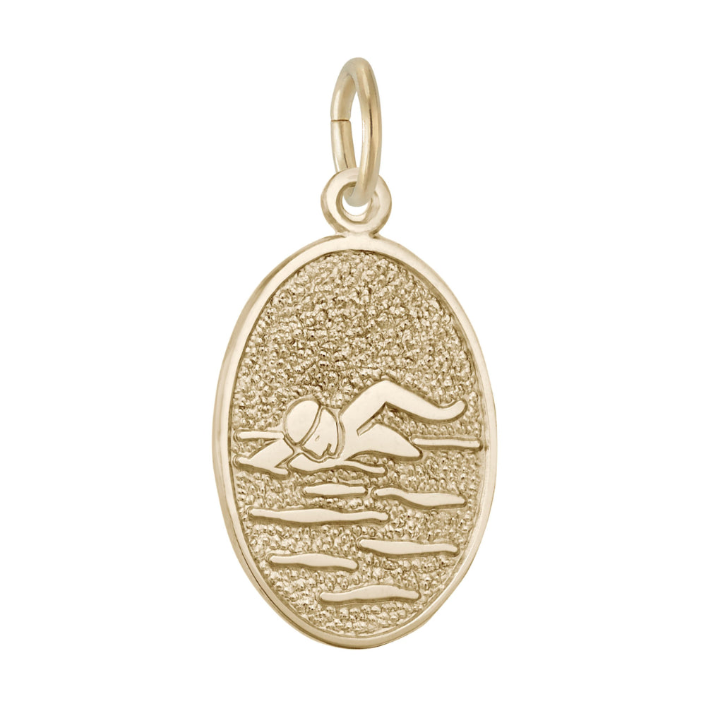 An oval gold charm featuring a textured background with an engraved figure of a swimmer, shown on a plain white background.