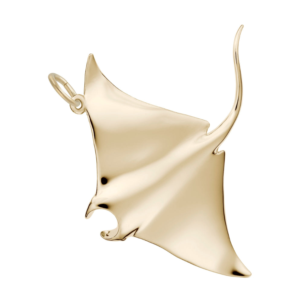 Polished gold manta ray charm on a white background