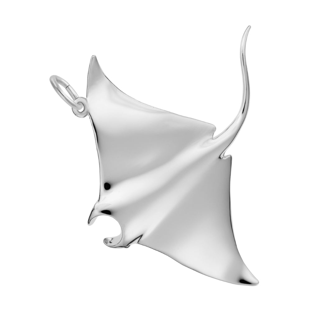 Polished silver manta ray charm on a white background