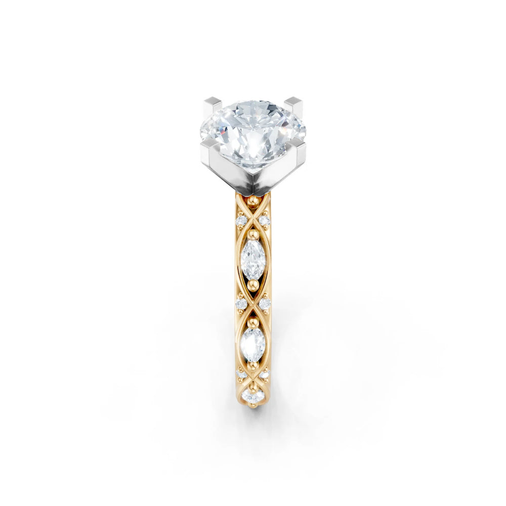 A yellow gold engagement ring with diamonds on the shank and a white gold head for a round center stone on a white background