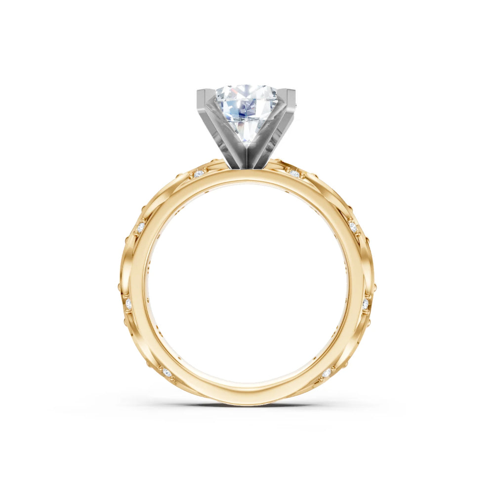 A yellow gold engagement ring with diamonds on the shank and a white gold head for a round center stone on a white background
