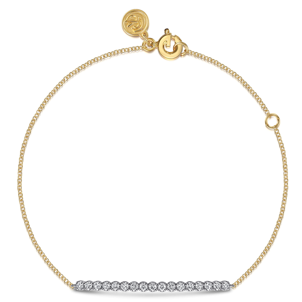 gold bracelet with white stones on white background