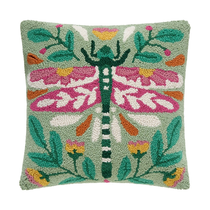Decorative pillow with a dragonfly design on a green background