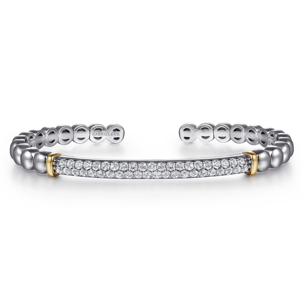 Silver bracelet with gold accents on a white background