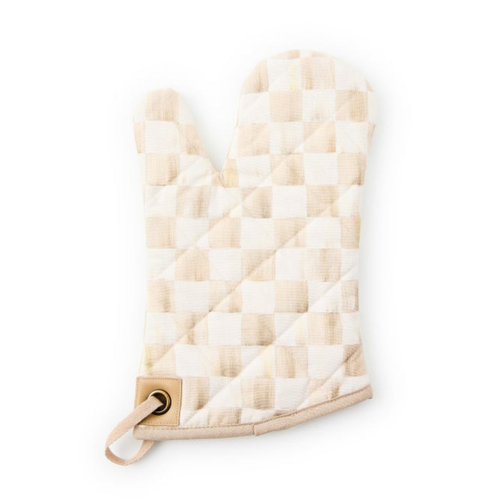 A quilted oven mitt featuring a beige and cream checkerboard pattern, with a tan leather-like loop and metal grommet at the wrist, shown on a plain white background.