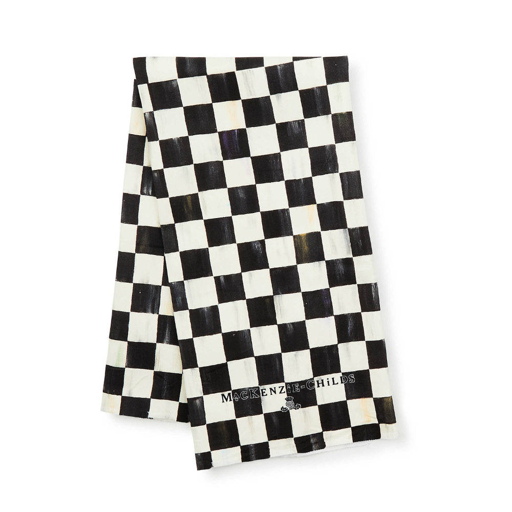 Black and white checkered towel with 'MacKenzie-Childs' branding on a white background