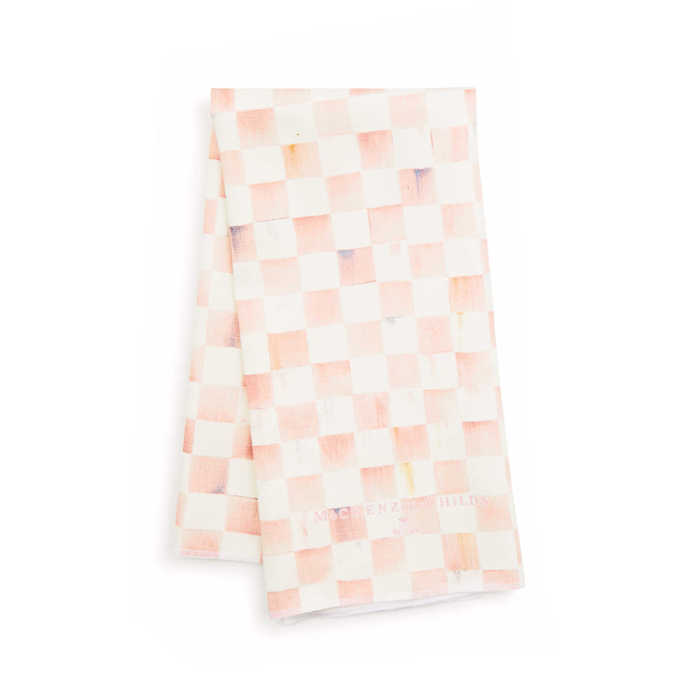 A pink and white checkered dish towel with the MacKenzie-Childs brand logo visible.
