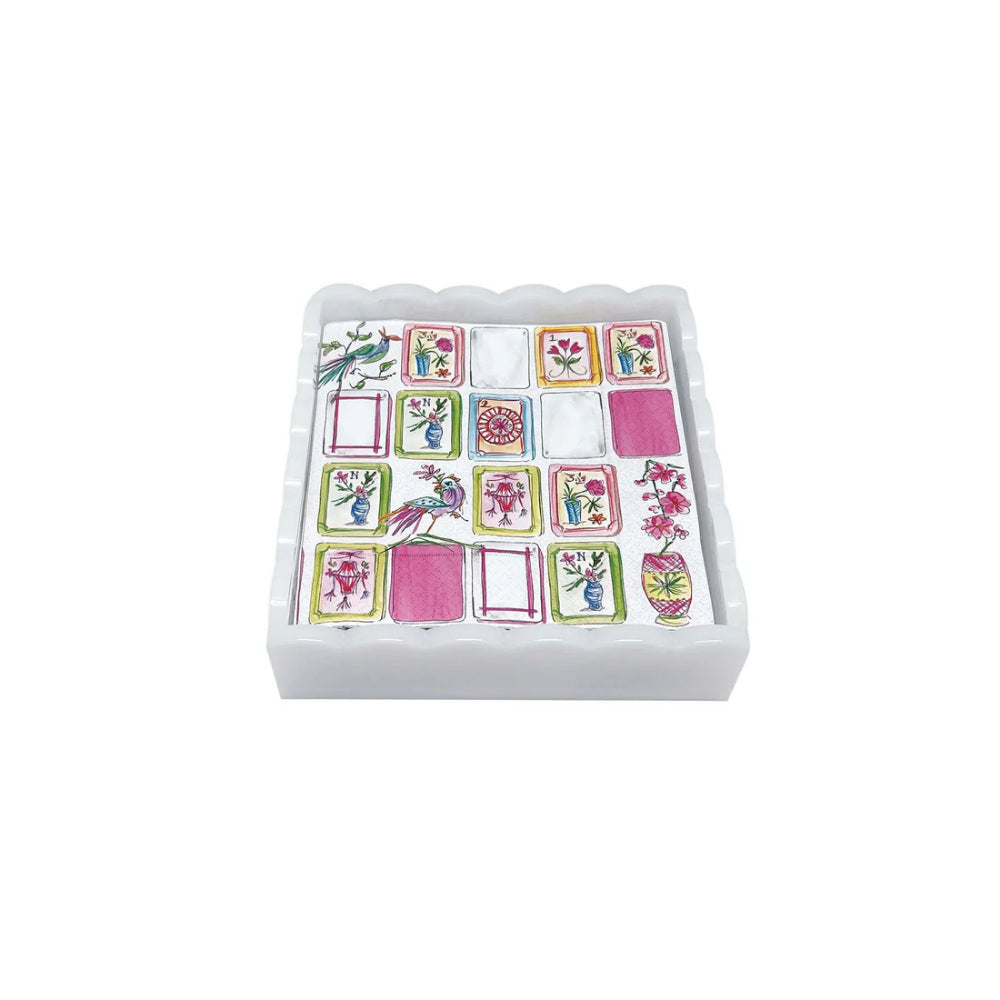 Set of playing card designs on a napkin with colorful patterns in a white box on a white background