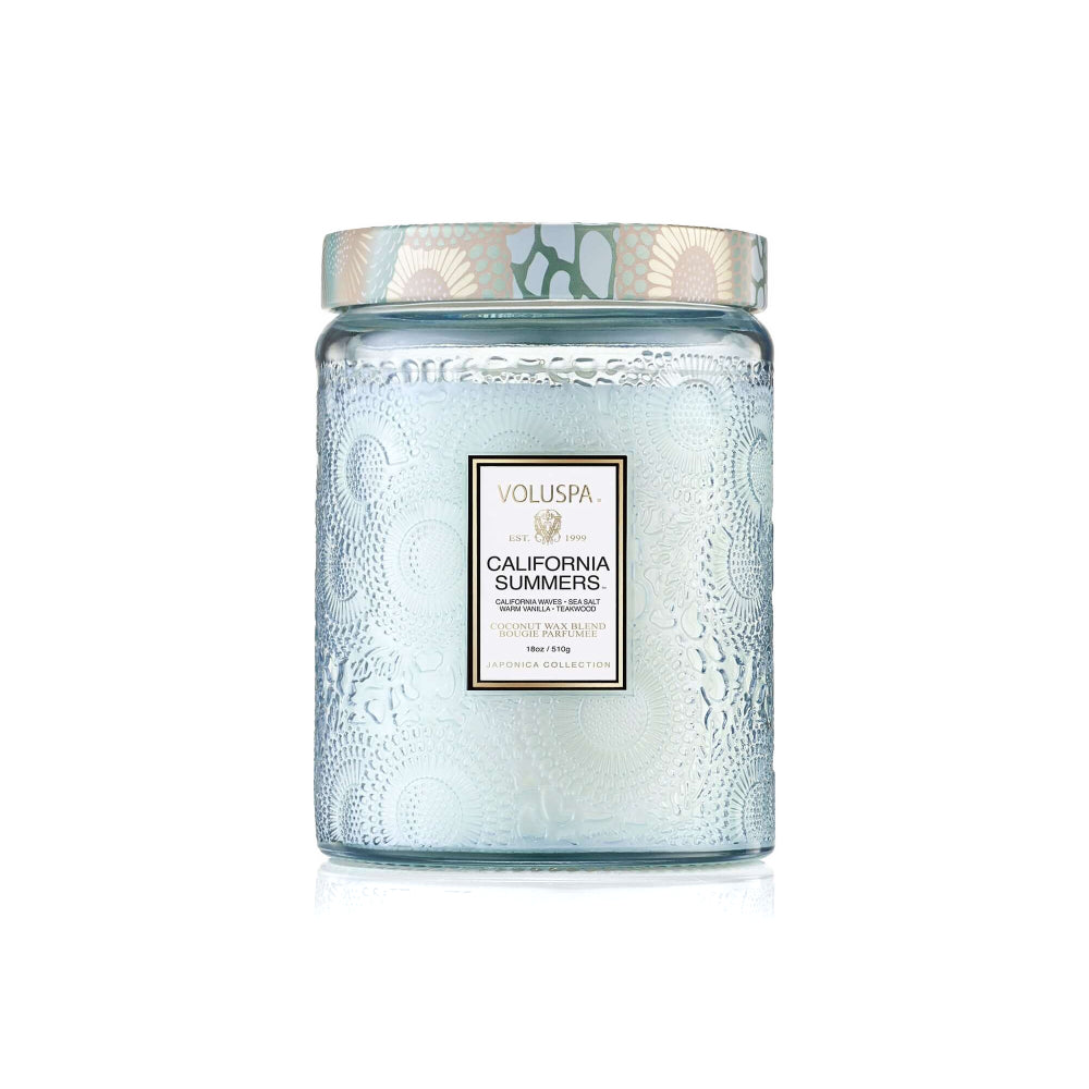 A Voluspa Candle Co. jar candle in a textured light blue glass container with a patterned lid, labeled 'California Summers' on a white background.
