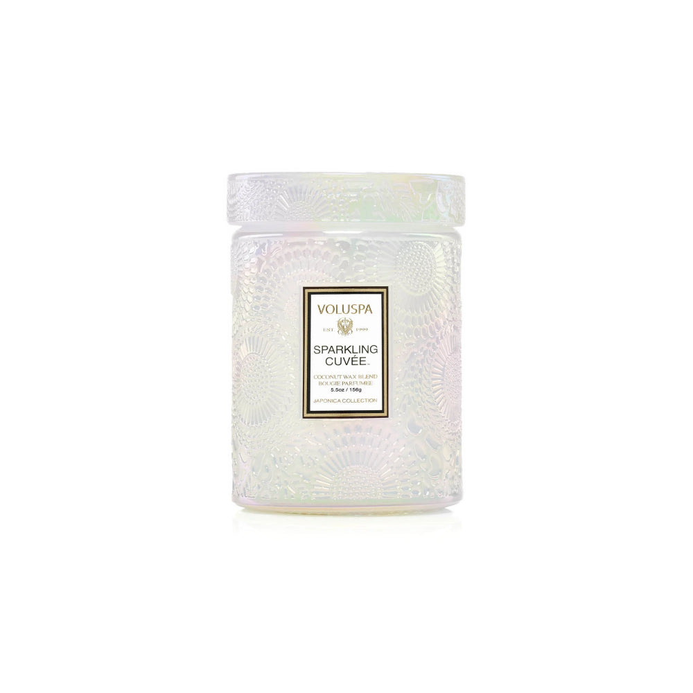 Small white Sparkling Cuvee candle on a white backround.  