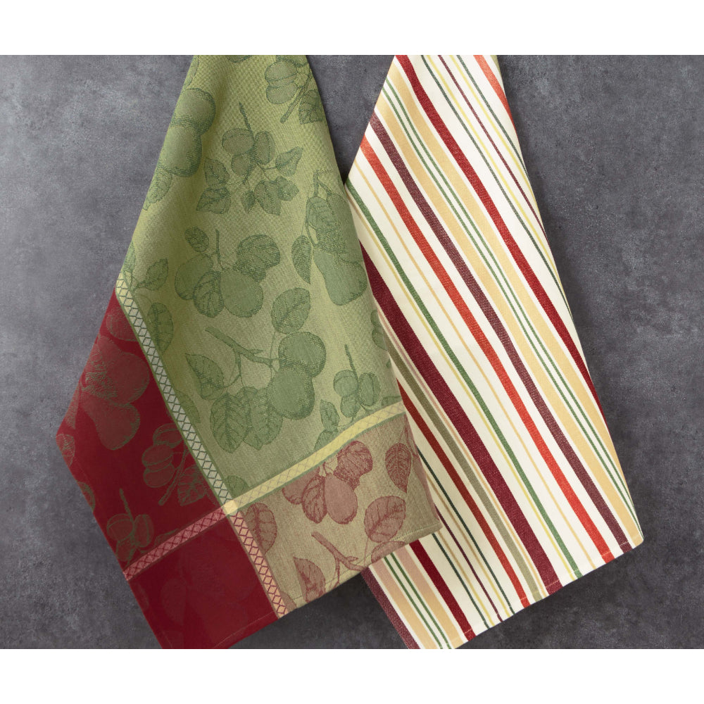 Two patterned towels, one with green leaf design and the other with red and beige stripes, on a gray surface.