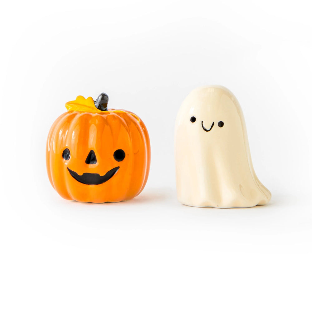 Halloween-themed salt and pepper shakers shaped like a pumpkin and a ghost on a white background