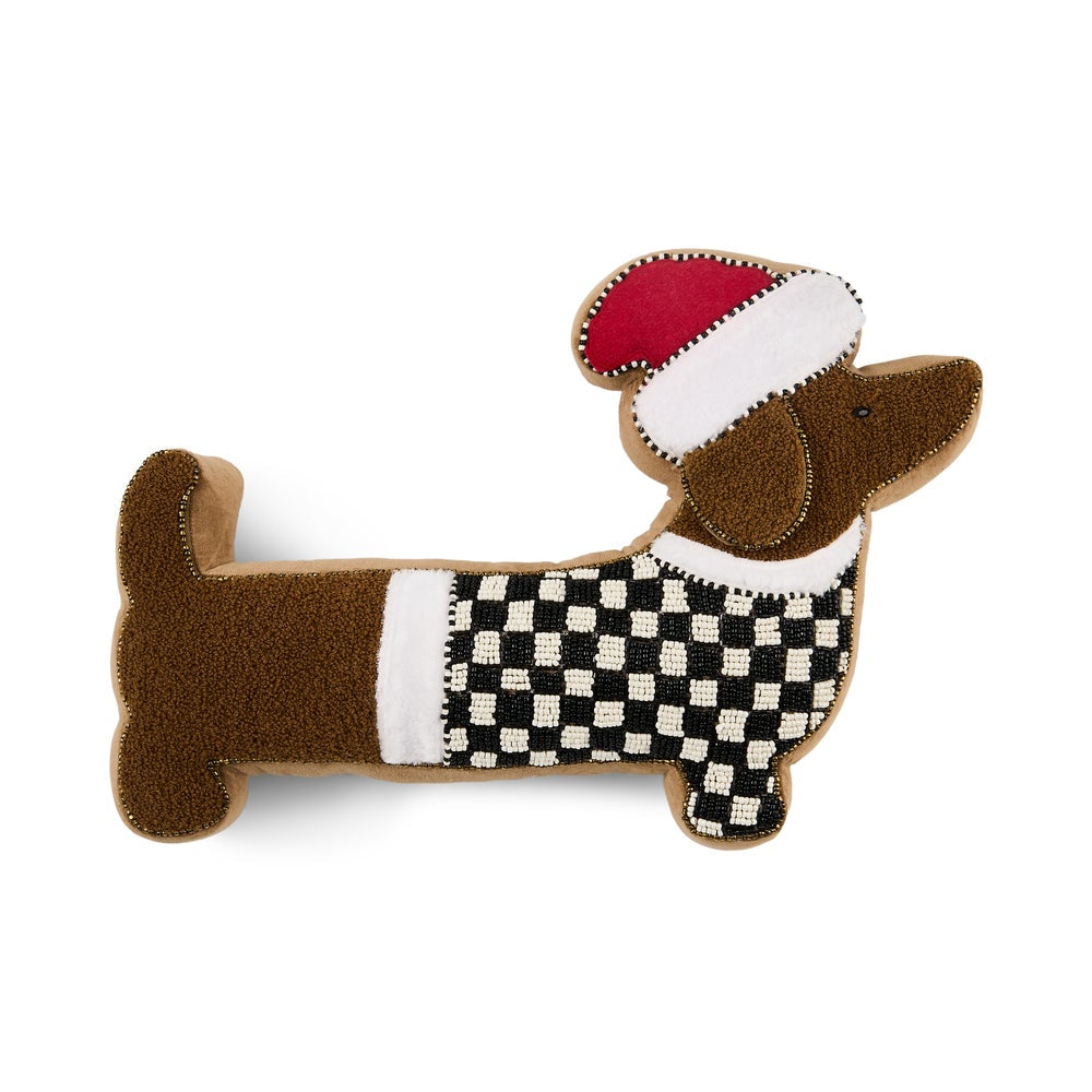 A dachshund-shaped plush pillow or cushion in brown felt, wearing a black-and-white checkered sweater and a red-and-white Santa hat, shown on a plain white background.