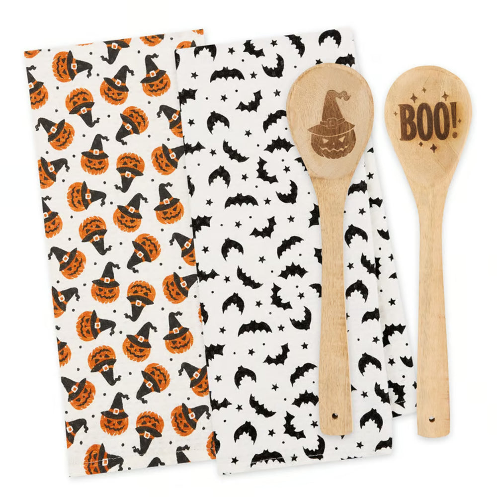Halloween-themed kitchen towel with pumpkins and bats, paired with two wooden spoons.