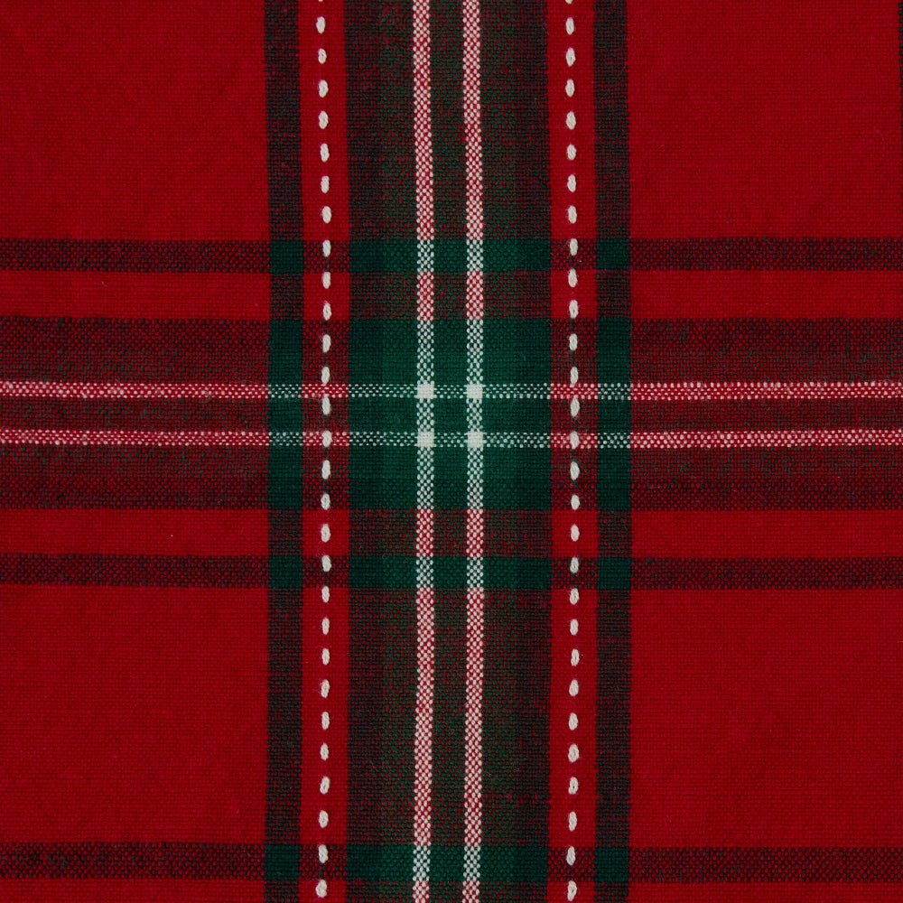 A close-up of a red tartan plaid fabric pattern with dark green, black, white, and thin pink stripes.